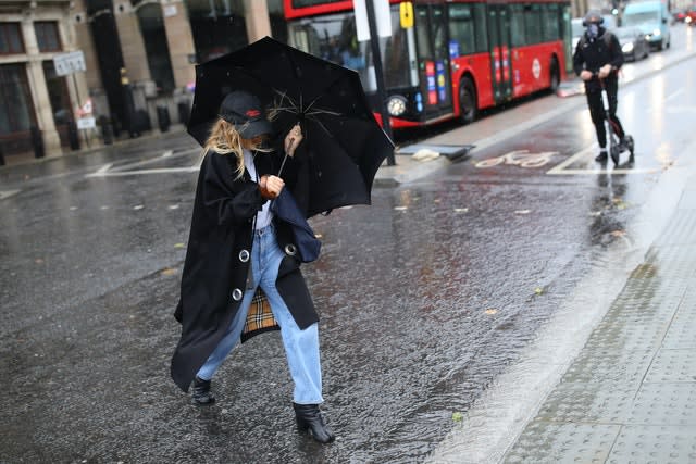 A woman walks through the rain in Westminster 