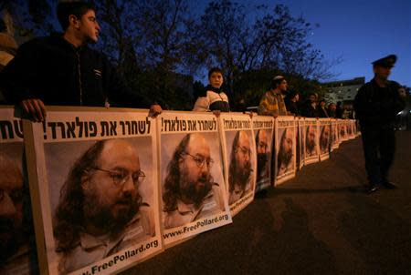 Israeli protesters hold posters calling for the release of Jonathan Pollard, who was imprisoned after being convicted for spying on the United States in 1987, during a demonstration in Jerusalem in this filephoto from November 23, 2005. REUTERS/Ronen Zvulun/Files