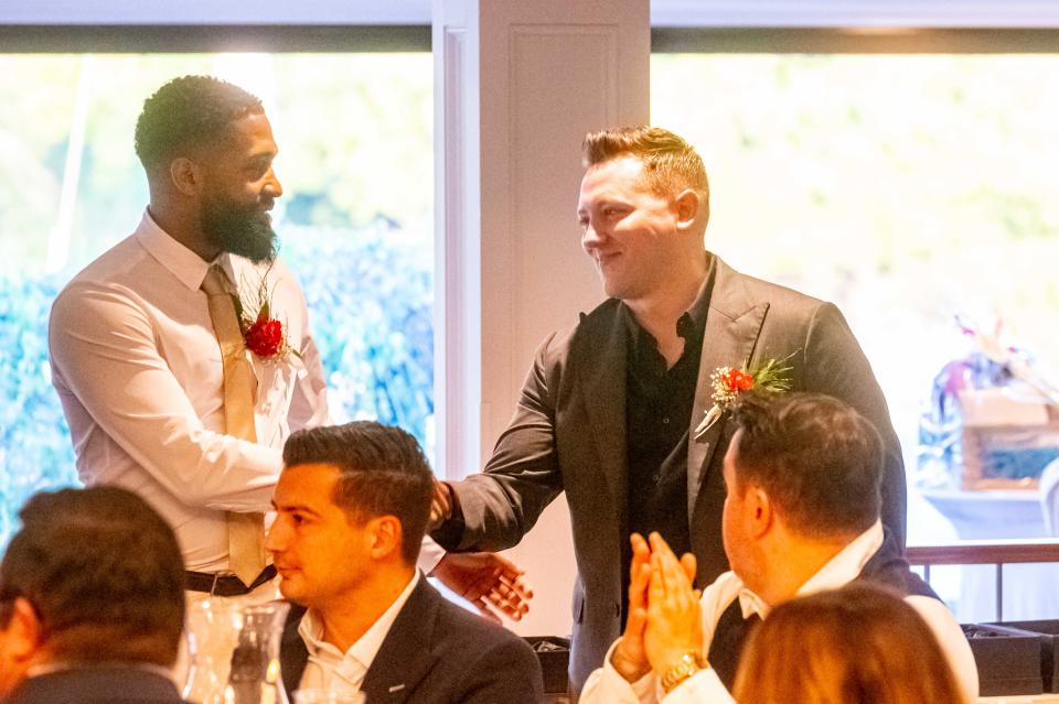 2024 New Bedford High School All Sport Hall of Fame Inductee Brian Rudolph shakes hands with Ryan Goddu.