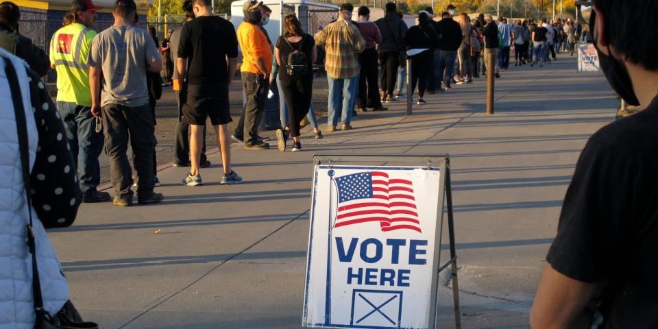 In this Nov. 3, 2020, file photo, mostly masked northern Nevadans wait to vote in-person at Reed High School in Sparks, Nev.,