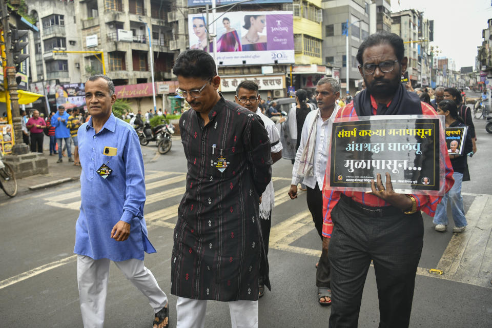 Avinash Patil, center, an activist and leader of the Maharashtra Andhashraddha Nirmulan Samiti, an anti-superstition group, marches on the 10th death anniversary of its founder and renowned rationalist, Narendra Dabholkar, who was gunned down during a morning walk in Pune, India, Sunday, Aug 20, 2023. The nones in India come from an array of belief backgrounds, including Hindu, Muslim and Sikh. The surge of Hindu nationalism has shrunk the space for the nones over the last decade, activists say. (AP Photo)