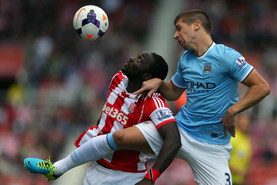 Stoke City's Kenwyne Jones jumps with Manchester City's Matija Nastasic (right) during the Barclays Premier League match at the Britannia Stadium, Stoke On Trent.