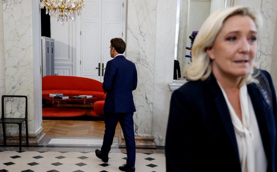  French far-right Rassemblement National (RN) leader and Member of Parliament Marine Le Pen walks away after being escorted by France's President Emmanuel Macron after talks at the presidential Elysee Palace, France, June 21, 2022 - REUTERS