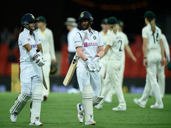 Taniya Bhatia and Deepti Sharma walk back as rain stopped play. (Image: ICC)