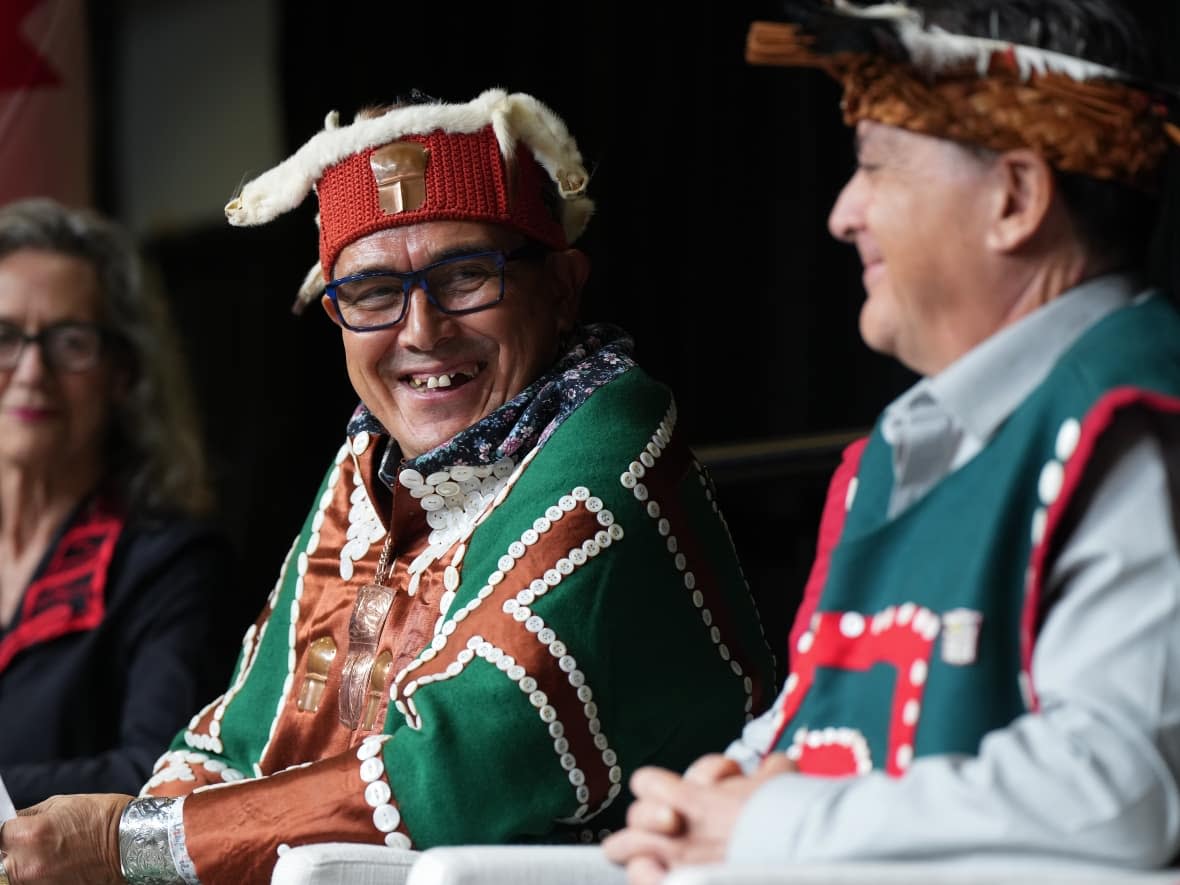 Chief Winidi (John Powell), centre, of the Mamalilikulla First Nation, sits with Fisheries Minister Joyce Murray, left, and former chief Richard Sumner during an announcement about a new marine refuge in the Gwaxdlala/Nalaxdlala (Lull Bay/Hoeya Sound) area in Knight Inlet on B.C.'s central coast, at the International Marine Protected Areas Congress (IMPAC5) in Vancouver, on Sunday. (Darryl Dyck/The Canadian Press - image credit)