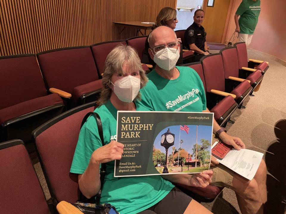 Glendale residents Debbie and Michael Eberhard attended Tuesday's City Council workshop clad in green shirts and holding up signs to save Murphy Park.