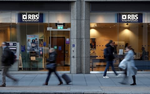 People walk past a branch of the Royal Bank of Scotland in London - Credit: Peter Nicholls/REUTERS