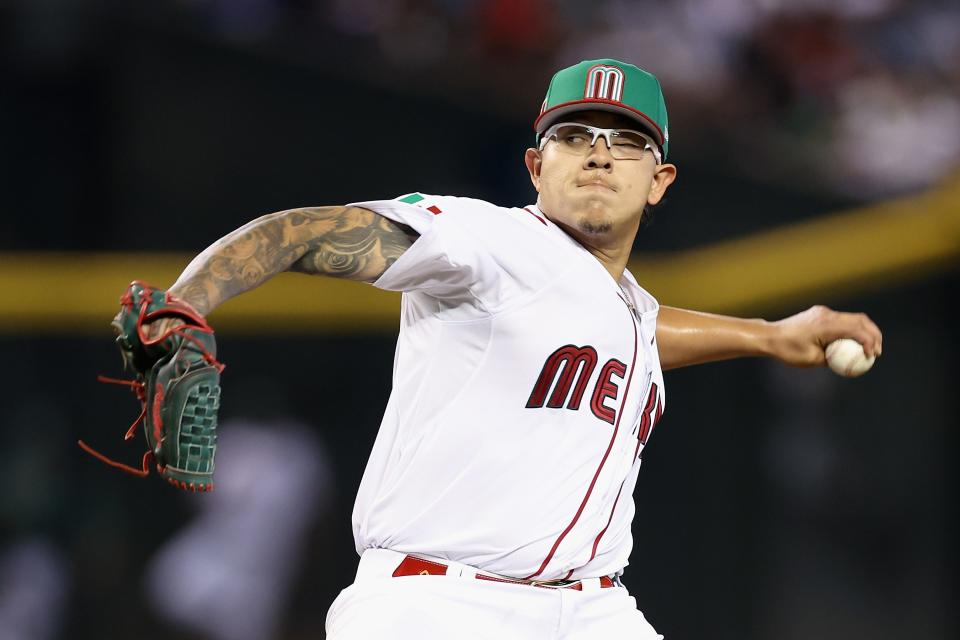 PHOENIX, ARIZONA - MARCH 11: Starting pitcher Julio UrÃ­as #7 of Team Mexico pitches against Team Colombia during the first inning of the World Baseball Classic Pool C game at Chase Field on March 11, 2023 in Phoenix, Arizona. (Photo by Christian Petersen/Getty Images)