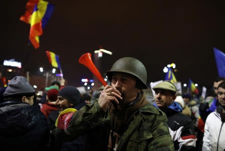 A man blows a horn during a demonstration in Bucharest, Romania, February 4, 2017. REUTERS/Stoyan Nenov