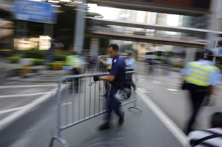 Police remove barricades at the main protest site in Admiralty in Hong Kong October 13, 2014. REUTERS/Carlos Barria