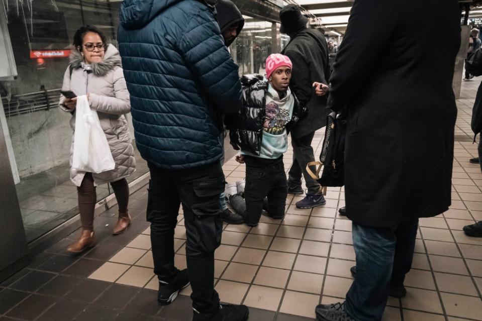 Undercover transit cops cops arrest a man who entered through the emergency exit without paying the fare. Stefano Giovannini