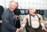 WELLINGTON, NEW ZEALAND - NOVEMBER 14: Prince Charles, Prince of Wales shares a laugh with Peter Hambleton, who plays the Dwarf Gloin in the new 'Hobbit' film, at Weta Workshop on November 14, 2012 in Wellington, New Zealand. The Royal couple are in New Zealand on the last leg of a Diamond Jubilee that takes in Papua New Guinea, Australia and New Zealand. (Photo by Jeff McEwan - PoolGetty Images)