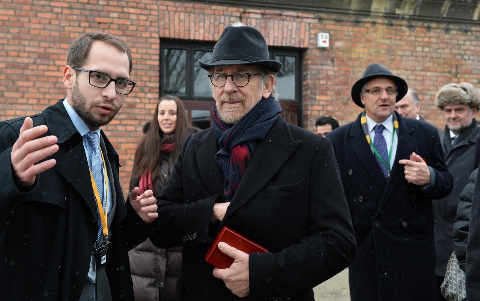 US director Steven Spielberg (C) is pictured on the sidelines of the unveiling of a plaque at the former Auschwitz concentration camp on January 27, 2015 at the camp's memorial site in Oswiecim, Poland. Seventy years after the liberation of Auschwitz, ageing survivors and dignitaries gather at the site synonymous with the Holocaust to honour victims and sound the alarm over a fresh wave of anti-Semitism. 