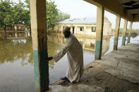 Musa Saleh, a 50-year-old islamic teacher, points at the level the water reached in the early days of floods at Tabawa Primary School northeastern Nigeria, Wednesday Oct. 26, 2022. The flooding that began in June has become the deadliest in more than a decade, according to authorities of this West African nation. More than 600 have been killed. Thousands of homes are destroyed, along with farmland. More than 1.3 million people have been displaced. Lives and livelihoods are upended.(AP Photo/Sunday Alamba)