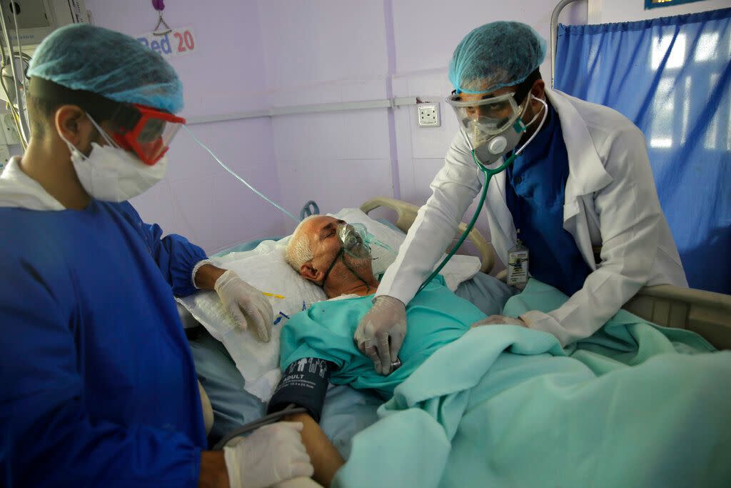 Medical workers attend to a COVID-19 patient in an intensive care unit at a hospital in Sanaa, Yemen, on June 14, 2020. (Photo: Hani Mohammed/AP)