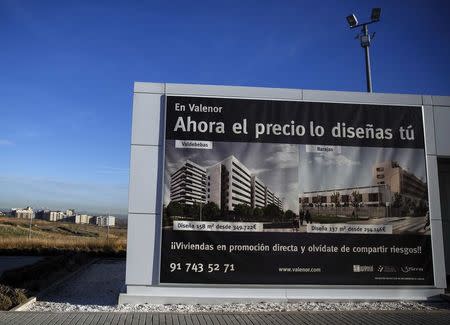 A publicity board announces a residential block in the Valdebebas neighbourhood in Madrid December 10, 2014. REUTERS/Andrea Comas