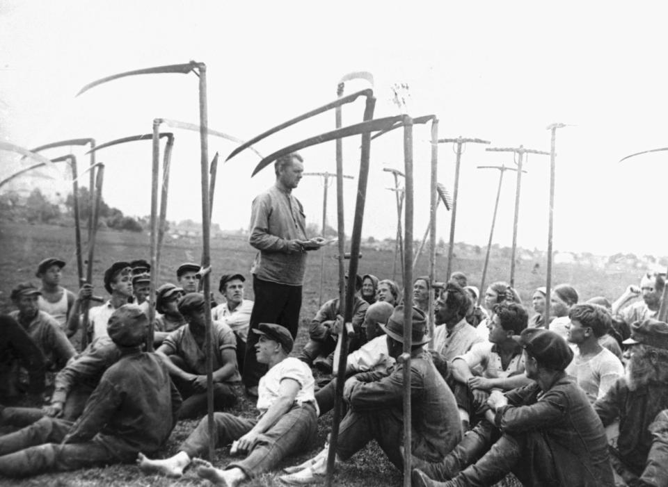 FILE - Workers of the Ivanouvsk region enjoy a respite from labor while holding a production meeting in the fields in December 1931 at Russia. Stalin implemented collectivization, in which private landholdings were incorporated into state and collective farms. (AP Photo/File)