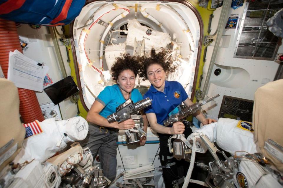 In this photo released by NASA on Thursday, Oct. 17, 2019, U.S. astronauts Jessica Meir, left, and Christina Koch pose for a photo in the International Space Station. On Friday, Oct. 18, 2019, the two are scheduled to perform a spacewalk to replace a broken battery charger.