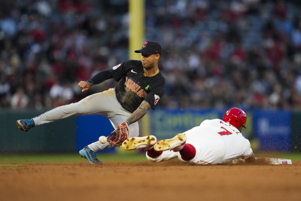 Los Angeles Angels' Jo Adell (7) is caught stealing second by Cleveland Guardians shortstop Brayan Rocchio, left, during the fourth inning of a baseball game in Anaheim, Calif., Saturday, May 25, 2024. (AP Photo/Ashley Landis)