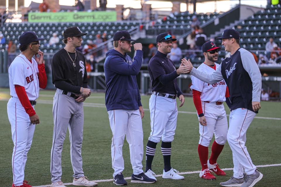 Detroit Tigers pitcher Ty Madden, right, greets Atlanta Braves pitcher Bryce Elder, center, and other former Texas players ahead of last year's UT alumni baseball game at UFCU Disch-Falk Field. Madden and Elder both held roles as Texas' Friday starter when they were Longhorns.