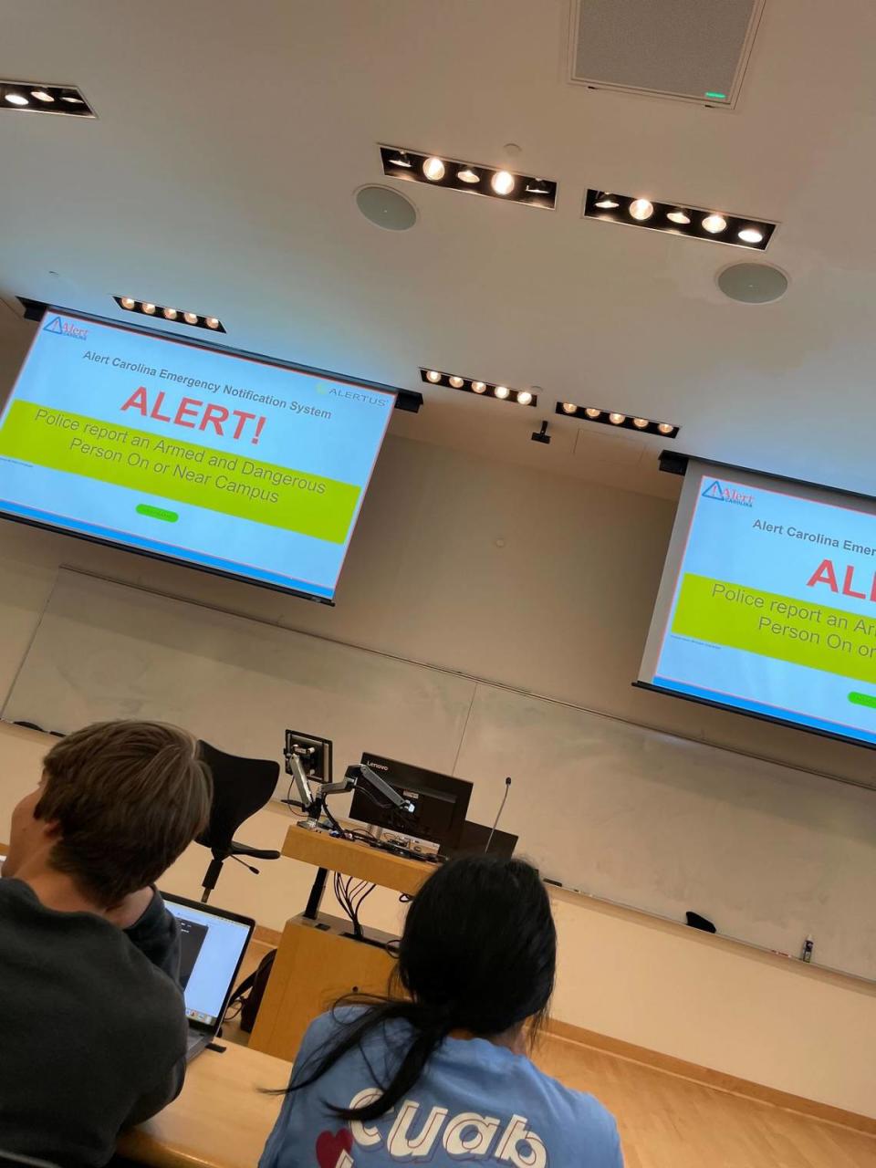 Students shelter in a classroom at UNC-Chapel Hill on Sept. 13, 2023, after an armed or dangerous person was reported on or near campus for the second time in less than three weeks.