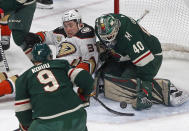 Anaheim Ducks' Nick Ritchie (37) lands on the ice as Minnesota Wild goalie Devan Dubnyk stops a shot in the first period of an NHL hockey game, Thursday, Jan. 17, 2019, in St. Paul, Minn. (AP Photo/Jim Mone)