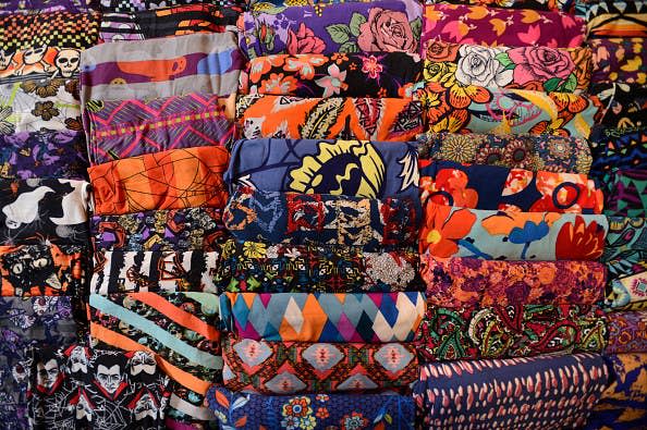 Hundreds of pairs of folded, colorfully printed leggings