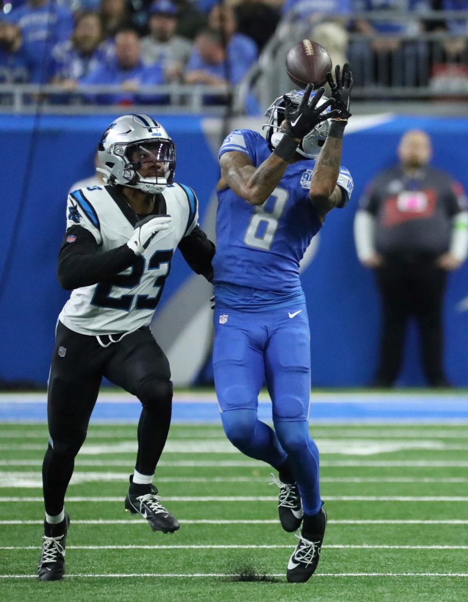 Detroit Lions wide receiver Josh Reynolds (8) catches a pass in front of Carolina Panthers cornerback CJ Henderson (23) during second-half action at Ford Field in Detroit on Sunday, Oct, 8, 2023.
