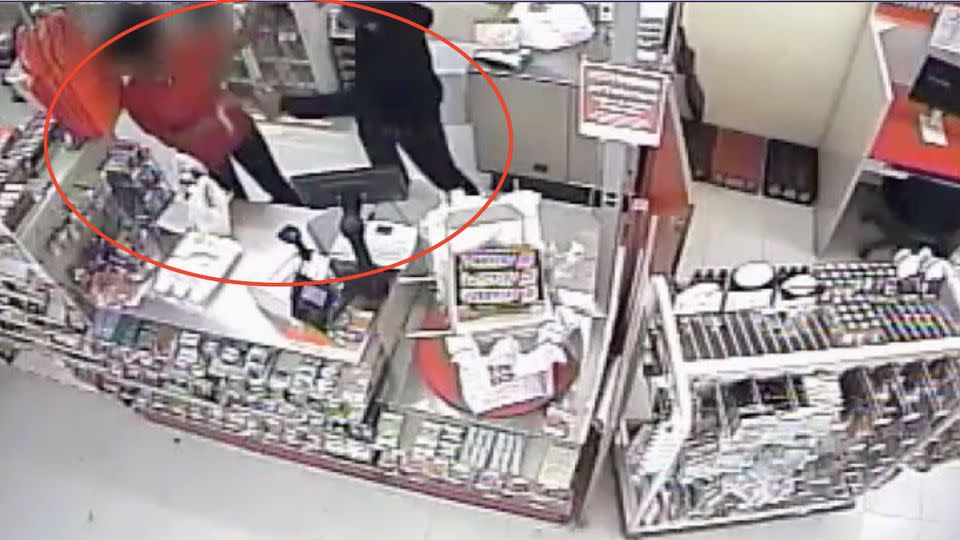 This is the terrifying moment an unmasked robber can be seen hitting an employee with a hammer. Photo: Philly Police