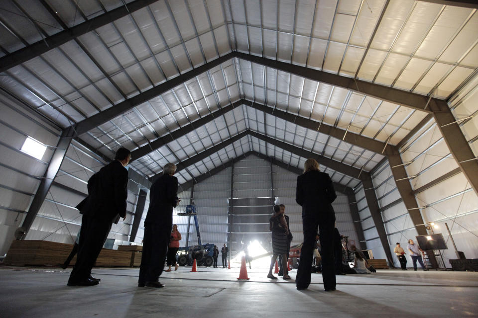 Officials and media arrive for a news conference inside a hanger built as the temporary home for the Endeavour Space Shuttle at the California Science Center in Los Angeles on Wednesday Aug. 8,2012. California Science Center officials say the space shuttle Endeavour is tentatively scheduled to arrive at LAX on Sept. 20,2012 and will remain at the airport until Oct. 13,2012 when it will be transported through city streets to science center in Exposition Park. It is scheduled to open to the public on Oct. 30. (AP Photo/Richard Vogel)