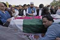 People attend the funeral prayer of slain senior Pakistani journalist Arshad Sharif, in Islamabad, Pakistan, Thursday, Oct. 27, 2022. Thousands of mourners in the capital, Islamabad on Thursday attended the funeral of the outspoken Pakistani journalist who was shot and killed by Nairobi police, as the spy chief and the military spokesman paid tributes to him because of his journalistic work and demanded a probe into his killing. (AP Photo/Anjum Naveed)