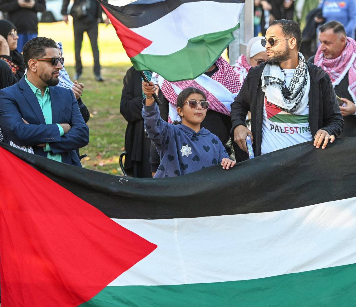 Pro Palestine supporters wave flags in Eaton Plaza before the start of a City of Fresno-sponsored Palestinian flag-raising ceremony to show support for the Palestinian community as war rages on in the Middle East on Friday, Dec. 8, 2023.