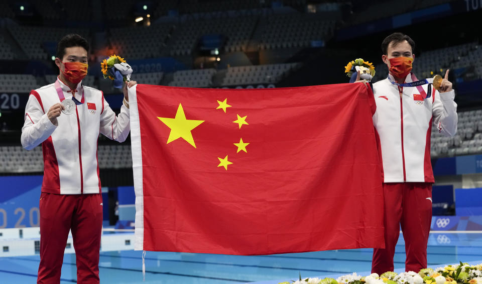 Wang Zongyuan of China, left, silver medal and Xie Siyi of China gold medal pose for a photo after men's diving 3m springboard final at the Tokyo Aquatics Centre at the 2020 Summer Olympics, Tuesday, Aug. 3, 2021, in Tokyo, Japan. (AP Photo/Dmitri Lovetsky)