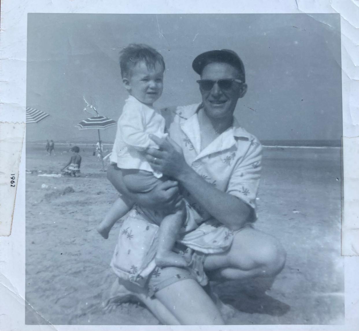 Jack Mullane holds his son, John Jr. on the beach at Stone Harbor, New Jersey in the summer of 1962.