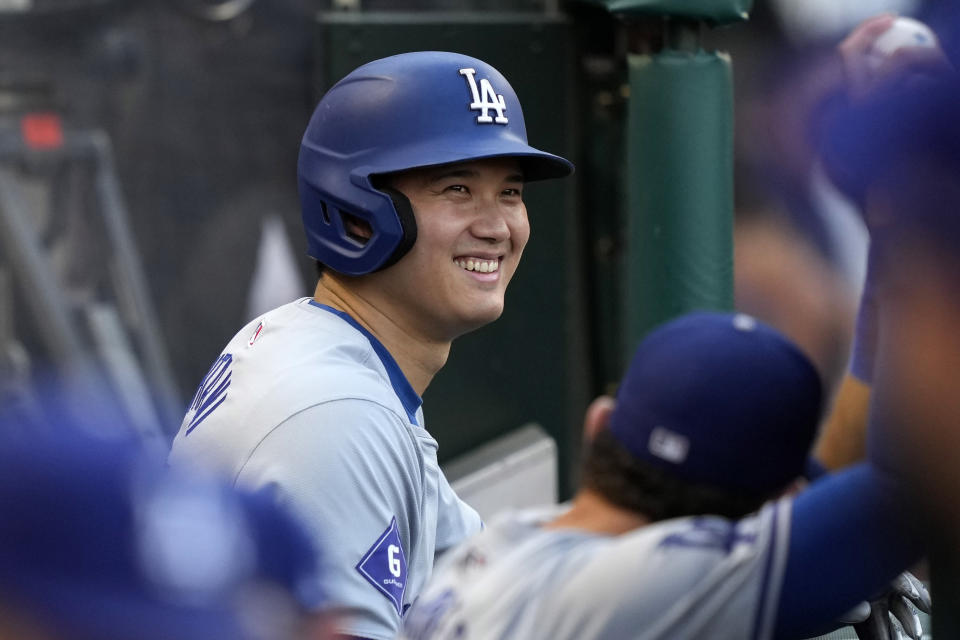 Los Angeles Dodgers' Shohei Ohtani smiles in the dugout prior to a baseball game against the Los Angeles Angels, Tuesday, Sept. 3, 2024, in Anaheim, Calif. (AP Photo/Mark J. Terrill)