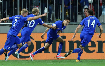 Finland’s Pyry Soiri celebrates scoring their first goal with teammates REUTERS/Antonio Bronic