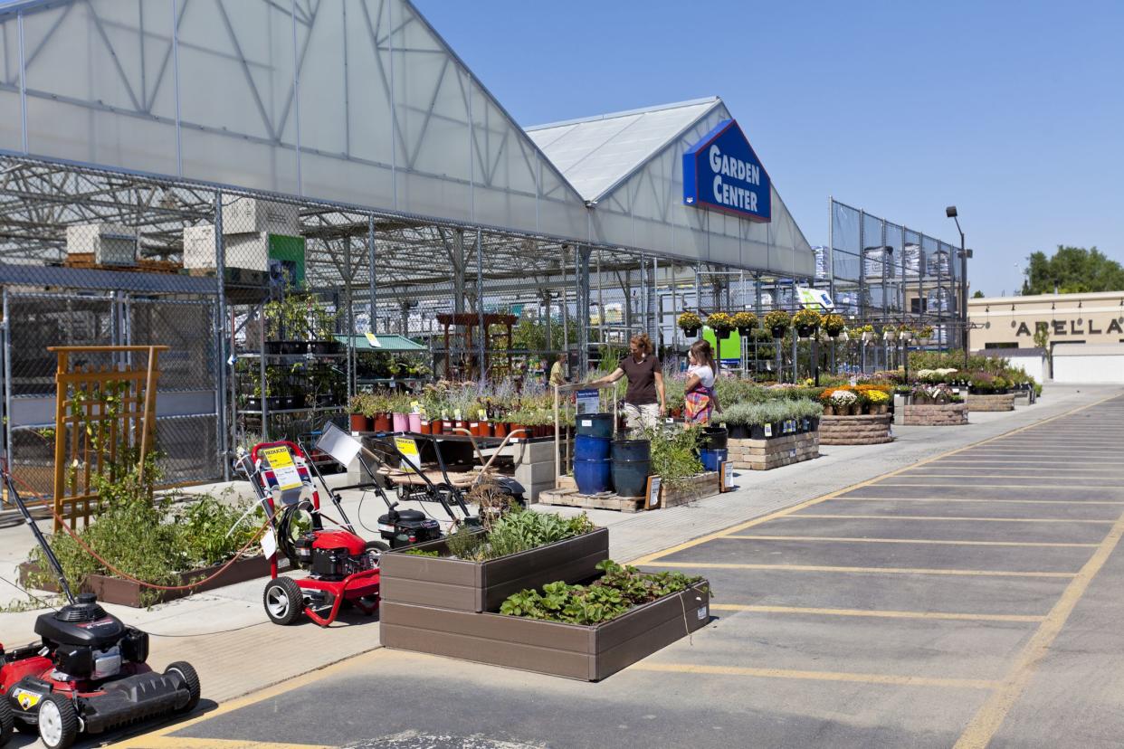 Bountiful, Utah, USA - September 7, 2011:  Two women look at the raised garden plants at Lowes in Bountiful, Utah on a fall day. One of the women is holding a baby.