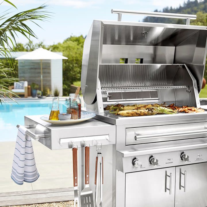 Outdoor gas grill next to a pool