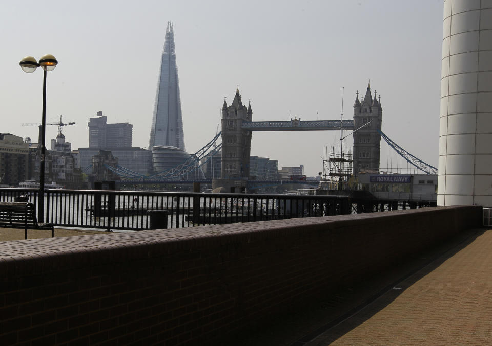 Tower Bridge and The Shard are seen from a cycle path in London, Thursday, May 24, 2012. There are many cycle paths across London that can be used to travel the capital. Like a runner or a swimmer, you would need to be physically fit. Like a goalie or a boxer, you should be prepared for close calls. But if you are coming to London's Summer Olympics _ and you have what it takes _ using a bicycle could be a great option in a city bracing for gridlock. (AP Photo/Kirsty Wigglesworth)