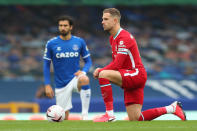 Everton's Portuguese midfielder André Gomes (L) and Liverpool's English midfielder Jordan Henderson take the knee before the English Premier League football match between Everton and Liverpool at Goodison Park in Liverpool, north west England on October 17, 2020. (Photo by Catherine Ivill / POOL / AFP) / RESTRICTED TO EDITORIAL USE. No use with unauthorized audio, video, data, fixture lists, club/league logos or 'live' services. Online in-match use limited to 120 images. An additional 40 images may be used in extra time. No video emulation. Social media in-match use limited to 120 images. An additional 40 images may be used in extra time. No use in betting publications, games or single club/league/player publications. / (Photo by CATHERINE IVILL/POOL/AFP via Getty Images)