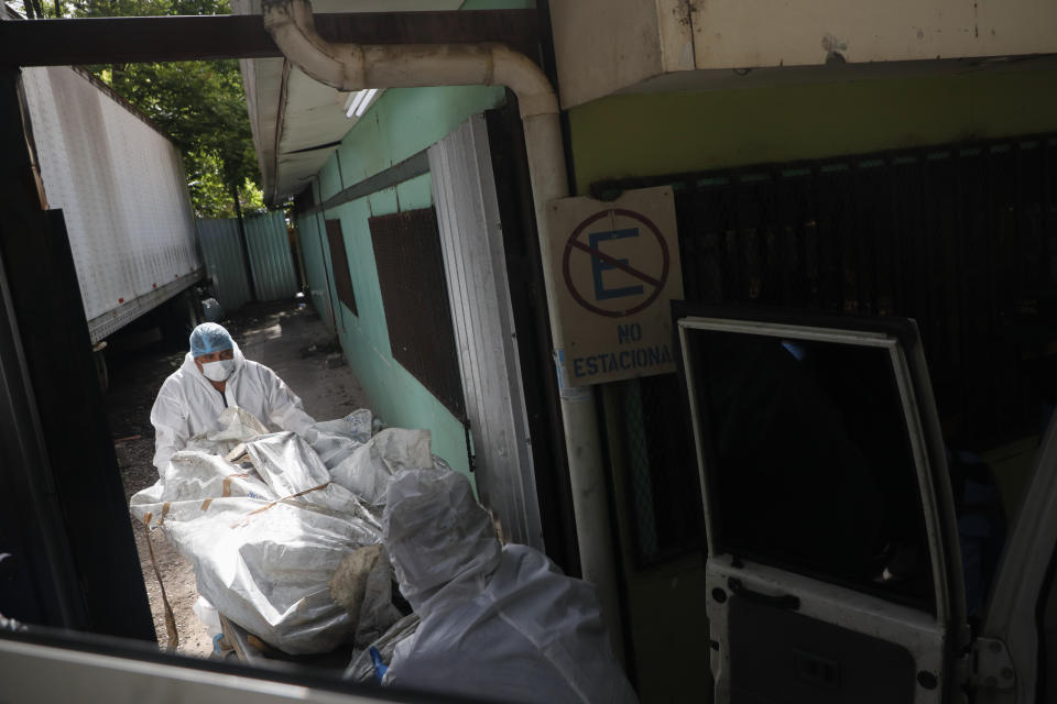 FILE - Forensic experts unload a body removed from a women's prison, at the medical morgue in Tegucigalpa, Honduras, Wednesday, June 21, 2023. President Xiomara Castro of Honduras, plans to build an isolated prison for 2,000 gang leaders on the Islas del Cisne archipelago 155 miles off the coast, part of a larger crackdown following the gang-related massacre of 46 women in one prison. (AP Photo/Elmer Martinez, File)