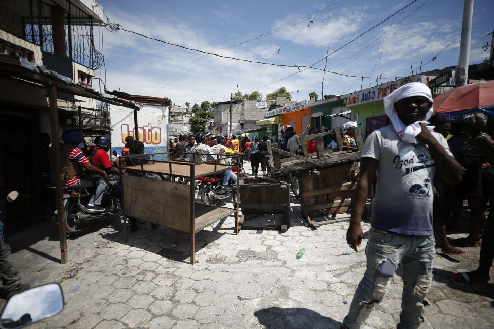 Haitians gather for a nationwide push to block streets and paralyze the country's economy as they press for President Jovenel Moise to give up power, in Port-au-Prince, Haiti, Monday, Sept. 30, 2019. Opposition leaders and supporters say they are angry about public corruption, spiraling inflation and a dwindling supply of gasoline that has forced many gas stations in the capital to close as suppliers demand the cash-strapped government pay them more than $100 million owed. (AP Photo/Rebecca Blackwell)