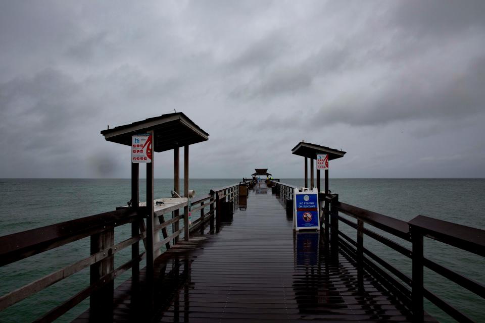 People visit Naples Pier as potential Tropical Storm Alex approaches Southwest Florida, Friday, June 3, 2022, at Naples Pier in Naples, Fla.