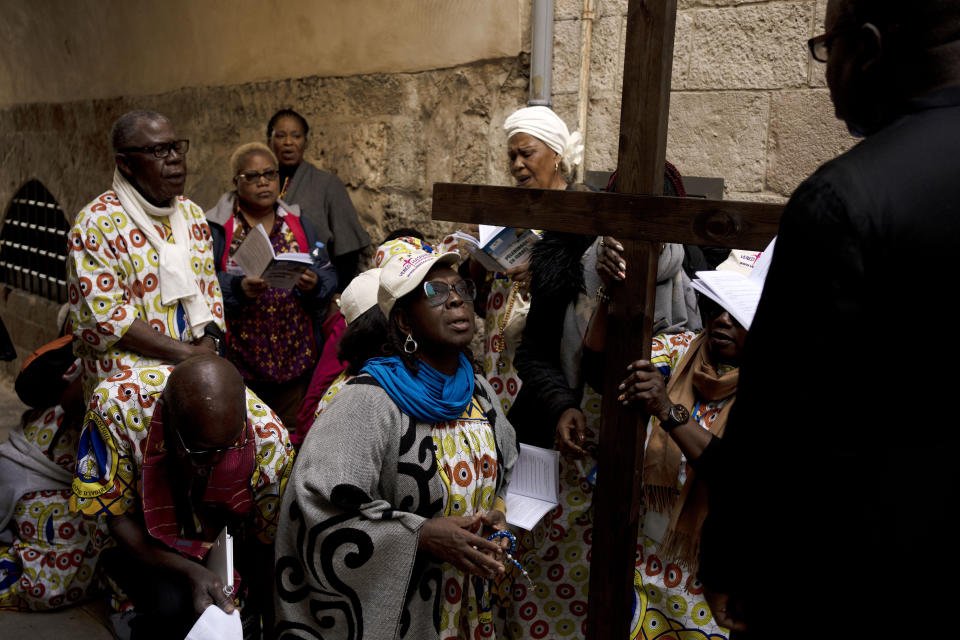 Christians pause along the Via Dolorosa, a route that is believed to be the path Jesus walked to his crucifixion, on Good Friday in the Old City of Jerusalem, Friday, April 7, 2023. (AP Photo/Maya Alleruzzo)