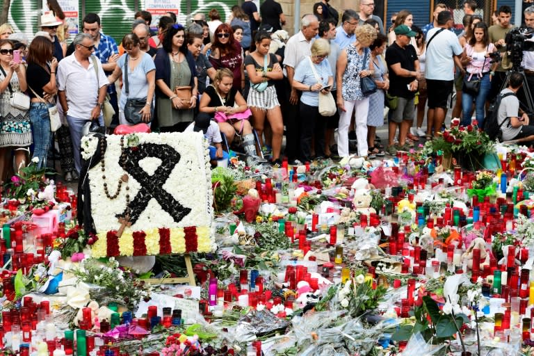 Flowers and candles are laid out on Las Ramblas boulevard in Barcelona in tribute to victims of the twin attacks in Spain