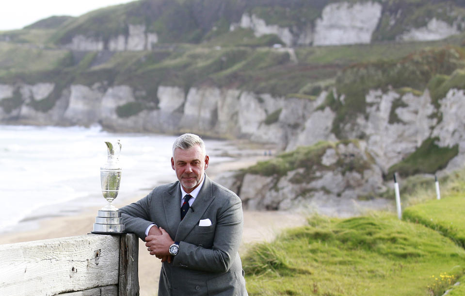 FILE - In this Tuesday, Oct. 20, 2015, file photo, Northern Ireland golfer and former Open golf winner Darren Clarke poses at Royal Portrush, Northern Ireland. His British Open title was part of the groundswell of support that led Royal Portrush to getting the British Open for the first time since 1951. (AP Photo/Peter Morrison, File)