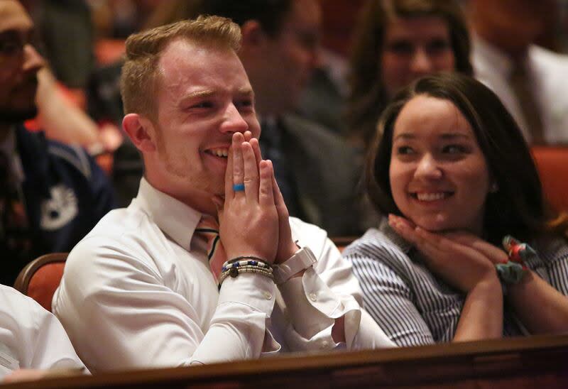 Peter Compton and Carolina Hashimoto react to LDS Church President Russell M. Nelson's announcement that there will be seven new temples around the world, including one in Layton, Utah, during the Sunday afternoon session of the 188th Annual General Confe