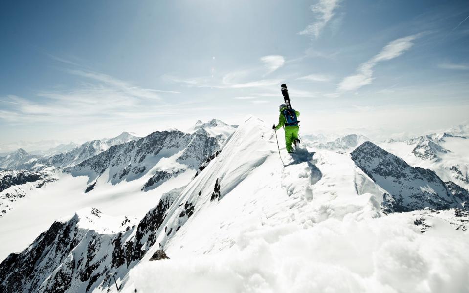 Skier walking on a snowy ridge