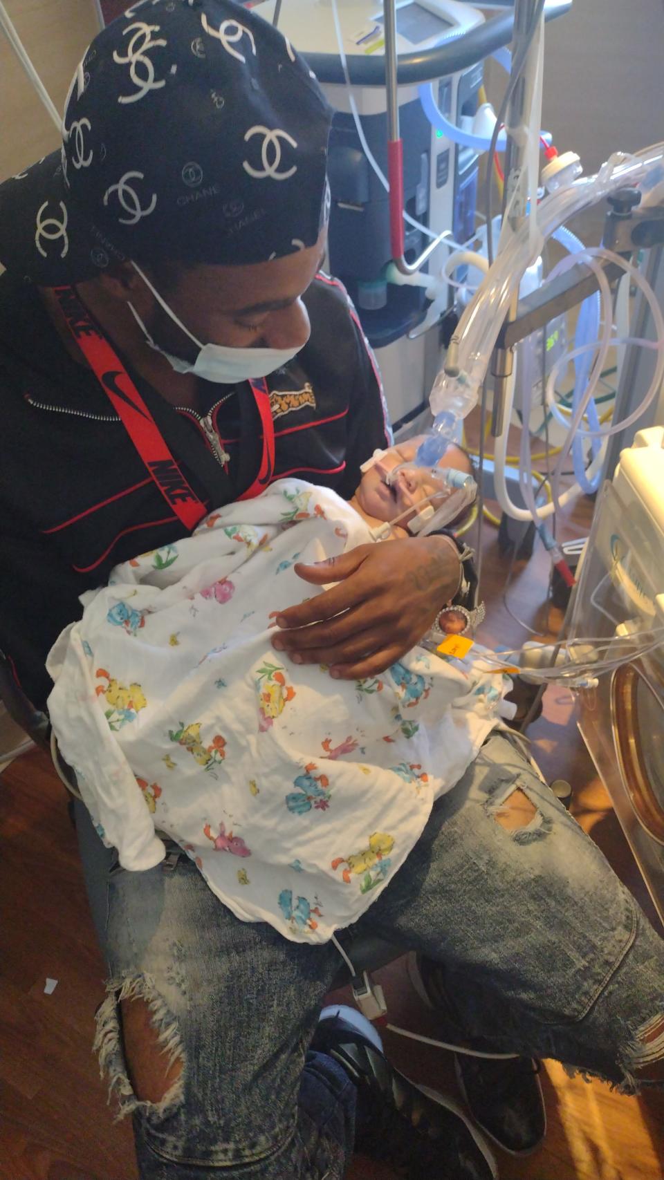 Justin Johnson holds his daughter, Amillianna Ramirez-Johnson, for the first and only time during her 30-hour life.