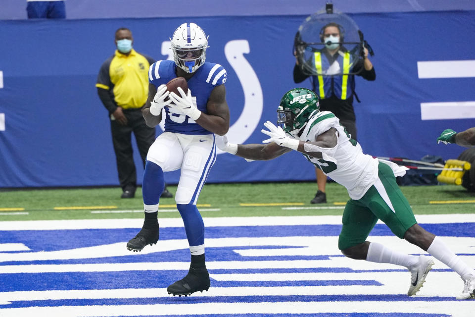 Indianapolis Colts tight end Mo Alie-Cox (81) catches a pass for a touchdown in front of New York Jets outside linebacker Tarell Basham (93) in the first half of an NFL football game in Indianapolis, Sunday, Sept. 27, 2020. (AP Photo/AJ Mast)